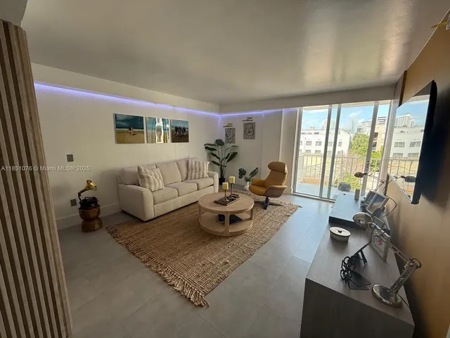 a living room with furniture window and flat screen tv