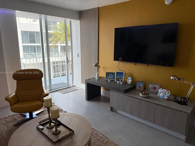 a kitchen with stainless steel appliances kitchen island granite countertop a refrigerator and a sink