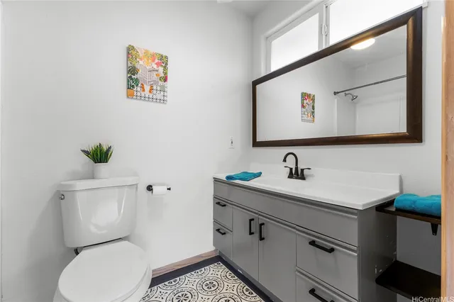 a bathroom with a toilet sink and mirror