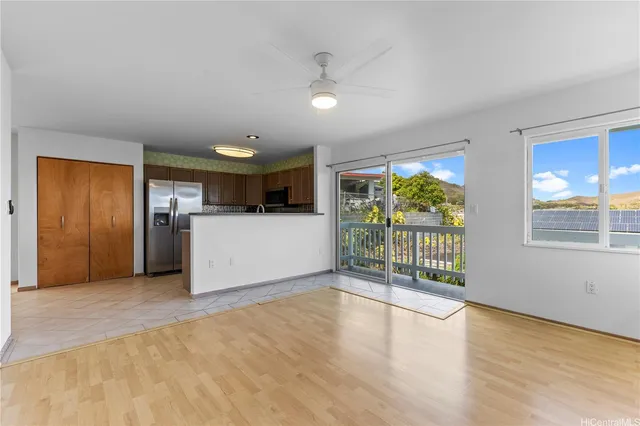a view of a electric appliances in kitchen and an empty room