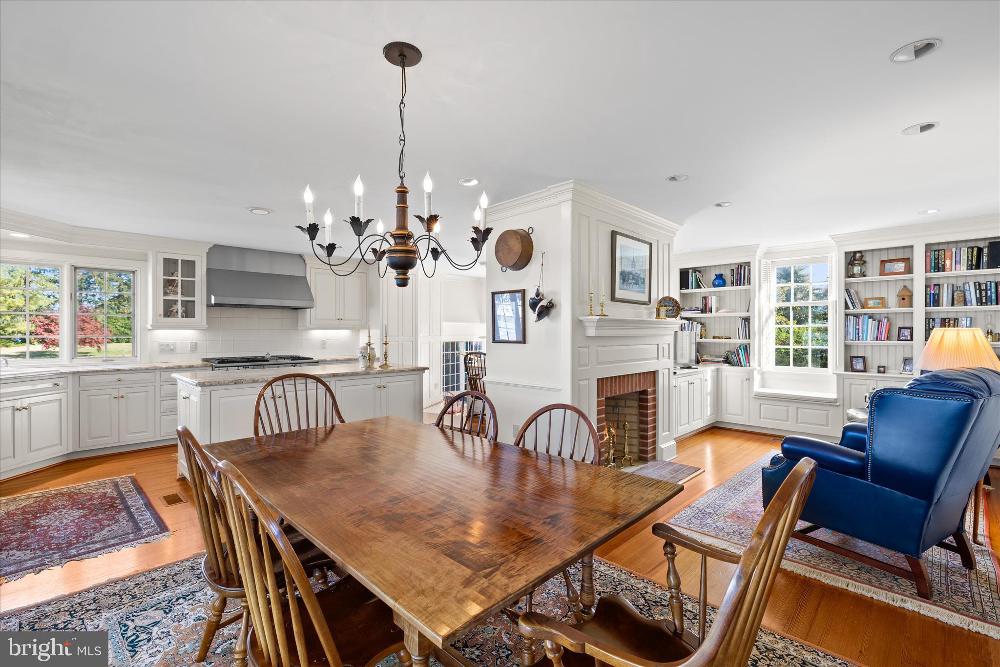 27473 Westpoint Road Easton, MD 21601 - Photo 13 of 58 a view of a dining room with furniture a chandelier and wooden floor