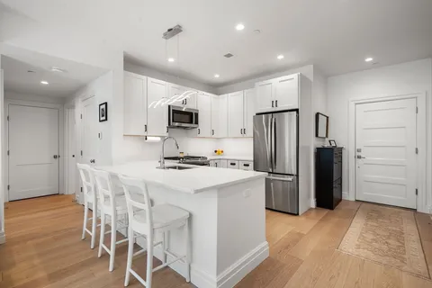 a kitchen with kitchen island a refrigerator stove and microwave