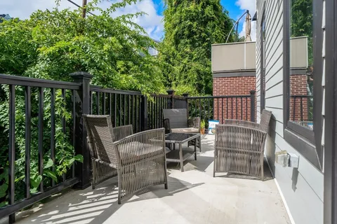 a view of backyard with outdoor seating and trees