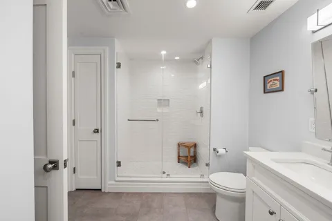 a bathroom with a toilet a sink and a shower