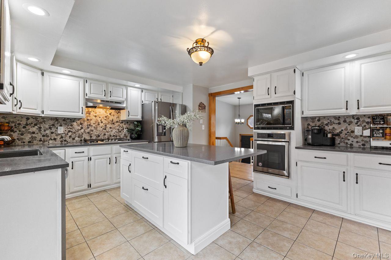 4 Stonewall Farm Road Mahopac, NY 10541 - Photo 10 of 36 Main floor kitchen. Updated with Quartz countertop center island and stainless steel appliances including 5 burner gas cooktop.