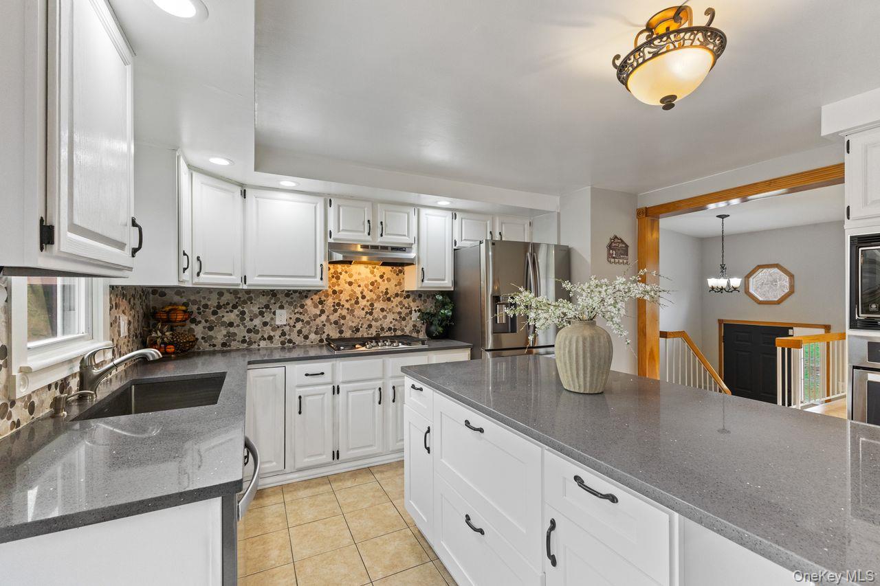 4 Stonewall Farm Road Mahopac, NY 10541 - Photo 13 of 36 Main floor kitchen. Updated with Quartz countertop center island and stainless steel appliances including 5 burner gas cooktop.