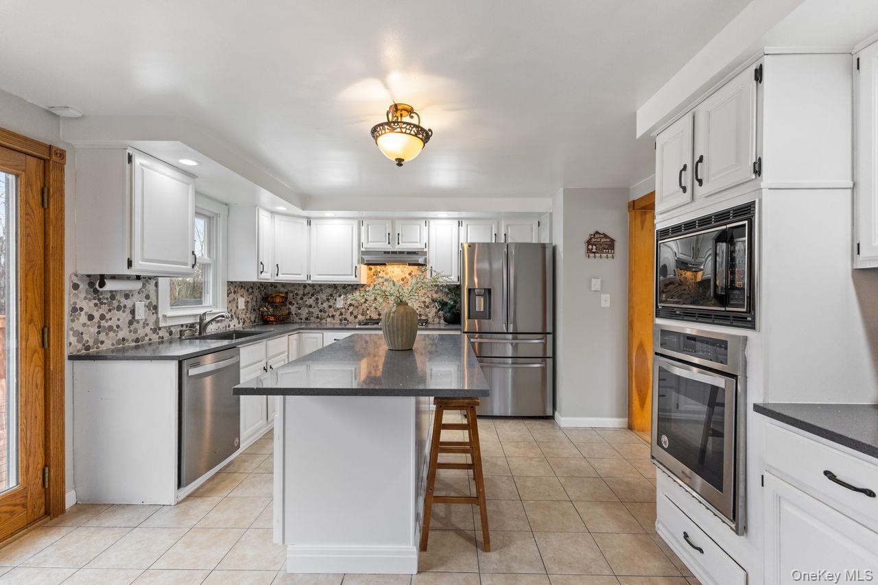 4 Stonewall Farm Road Mahopac, NY 10541 - Photo 2 of 36 Main floor kitchen. Updated with Quartz countertop center island and stainless steel appliances including 5 burner gas cooktop.