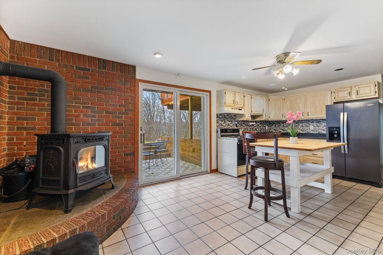 4 Stonewall Farm Road Mahopac, NY 10541 - Photo 24 of 36 Lower level in law suite with pellet stove and sliding glass doors to yard.