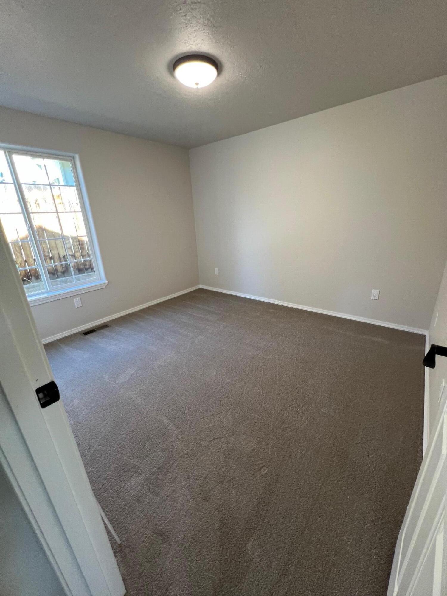 629 Deer Ridge Court Madras, OR 97741 - Photo 22 of 39 an empty room with windows