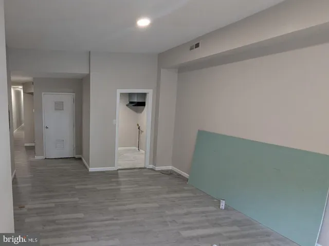 a view of hallway with wooden floor