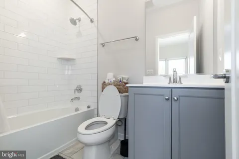 a bathroom with a granite countertop toilet sink and shower