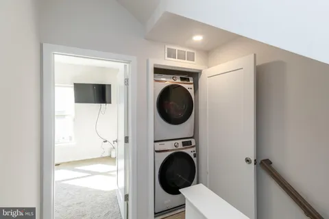 a view of a hallway with washer and dryer