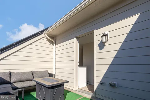 a balcony with furniture and wooden floor