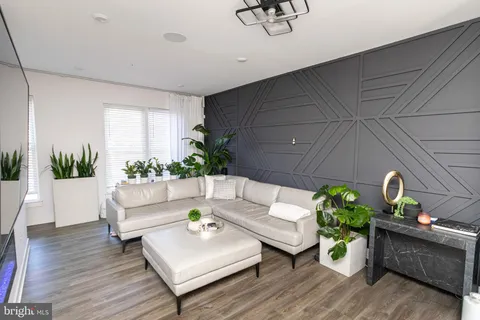 a living room with furniture and flowers