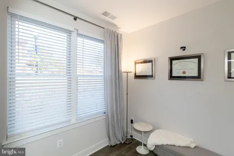 a bathroom with a toilet a sink and a window