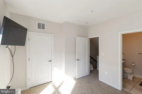a view of a room with wooden floor and cabinet