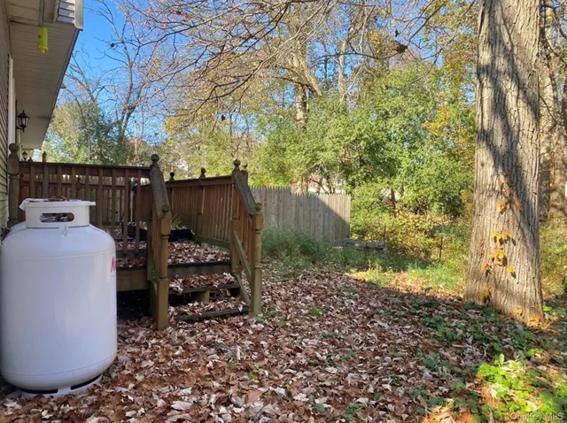 a view of a porch with furniture and a yard