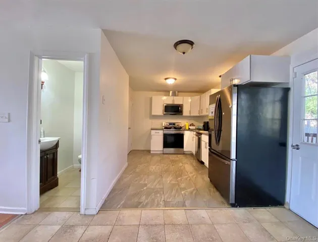 a large kitchen with a large counter top stainless steel appliances and cabinets