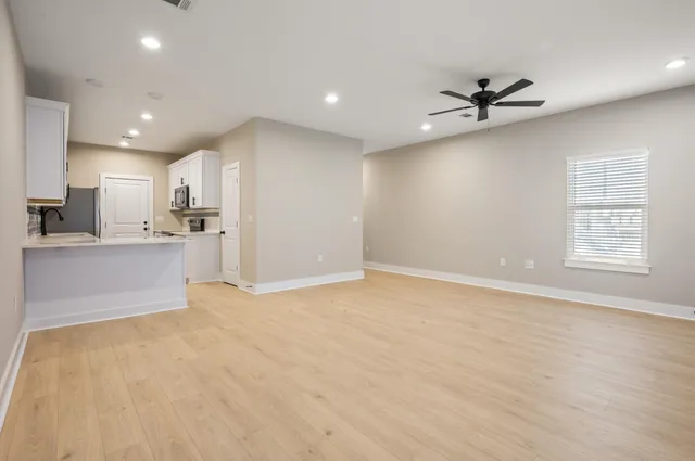 a view of a kitchen with a sink and a window