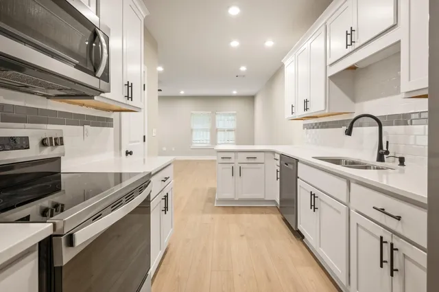 a kitchen with stainless steel appliances granite countertop a sink and cabinets