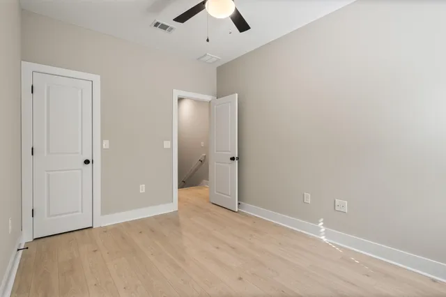 an empty room with fan and entrance