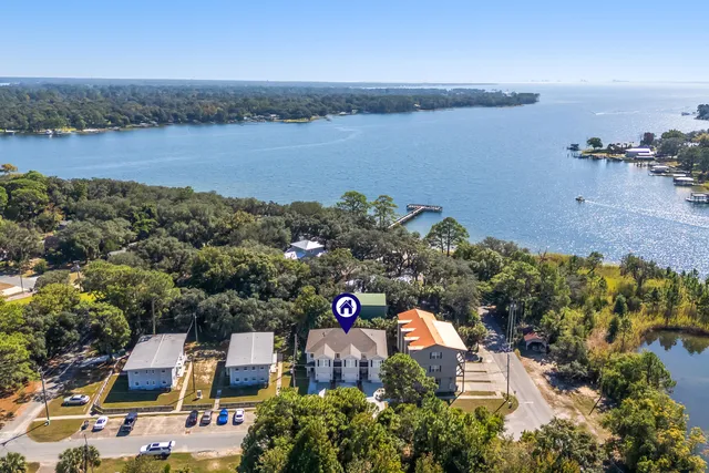 an aerial view of a house with a lake view