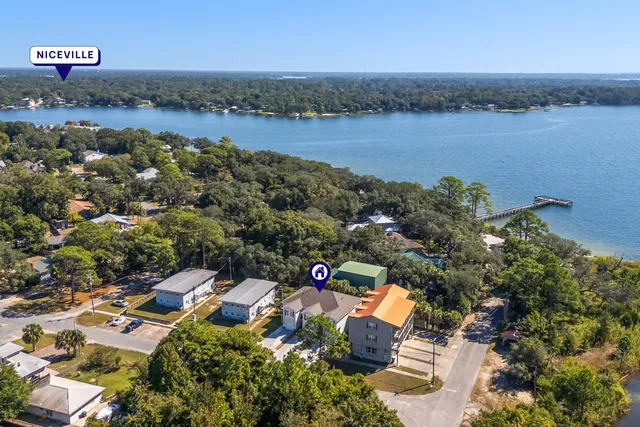 an aerial view of a house with lake view