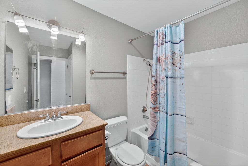 41 Grandview Street, Unit 1204 Santa Cruz, CA 95060 - Photo 17 of 32 a bathroom with a sink toilet mirror and shower
