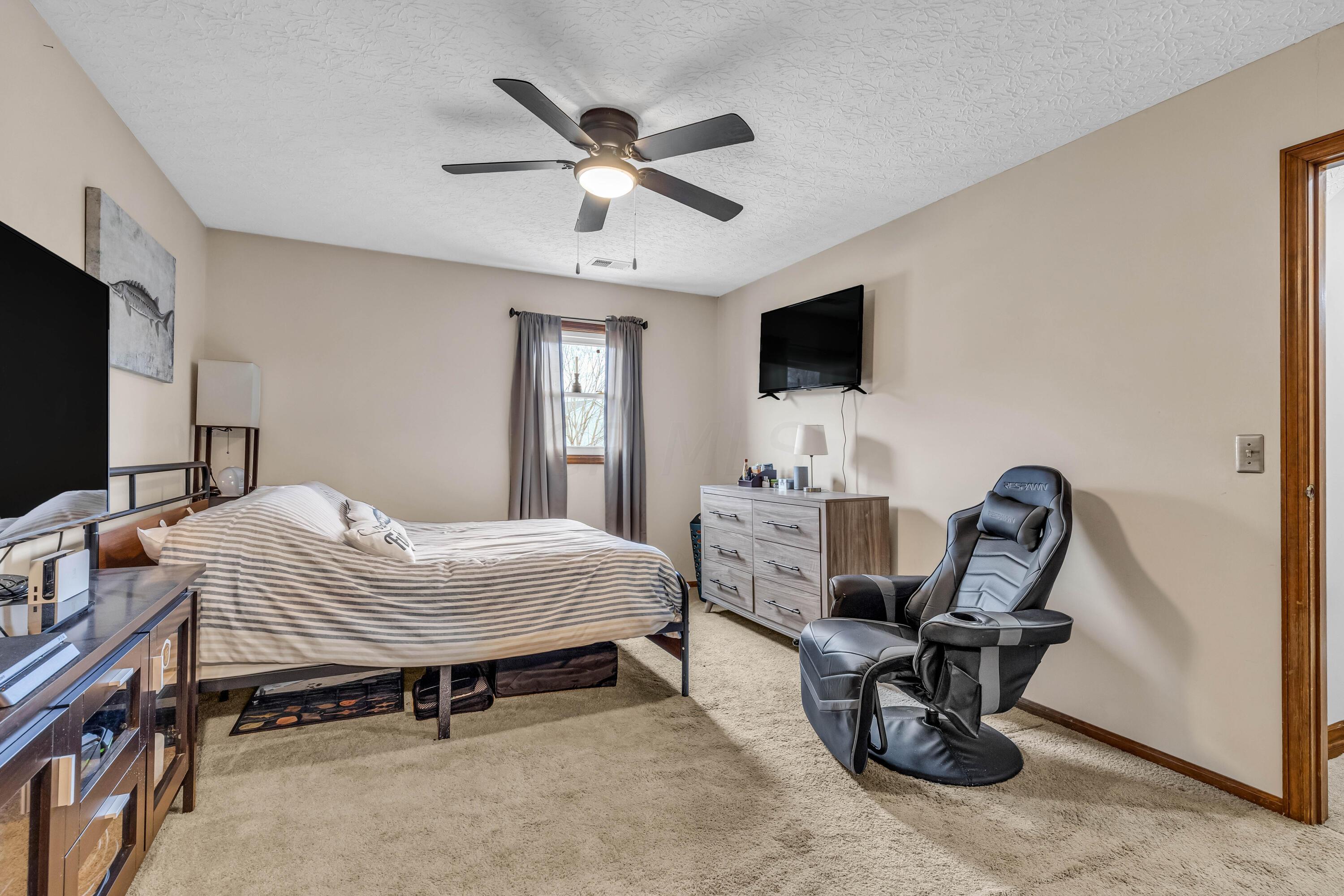 435 Emory Street Gahanna, OH 43230 - Photo 36 of 54 • Light sand carpet
• Tan painted walls
• Lighted ceiling fan
• Drapes remain