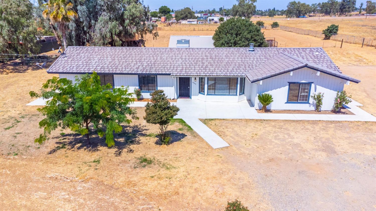 an aerial view of a house with a yard and lake view
