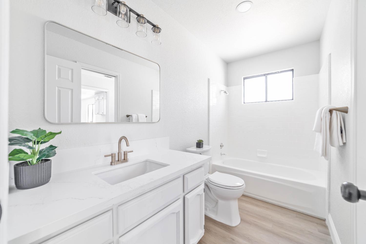 16680 Austin Street Madera, CA 93638 - Photo 11 of 40 a bathroom with a sink a toilet and shower