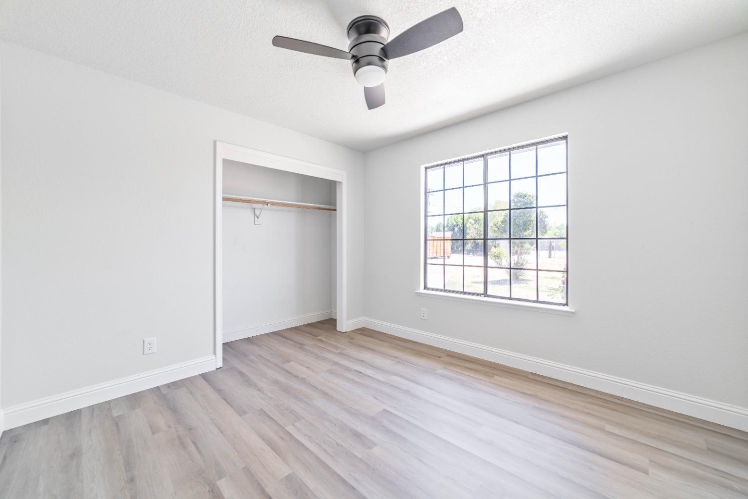 16680 Austin Street Madera, CA 93638 - Photo 15 of 40 wooden floor in an empty room with a window