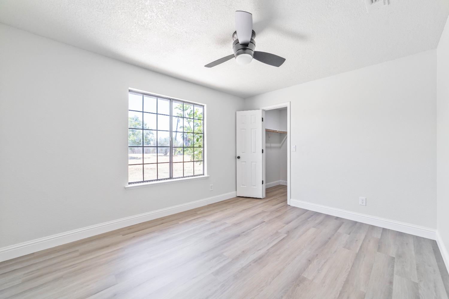 16680 Austin Street Madera, CA 93638 - Photo 16 of 40 wooden floor in an empty room with a window
