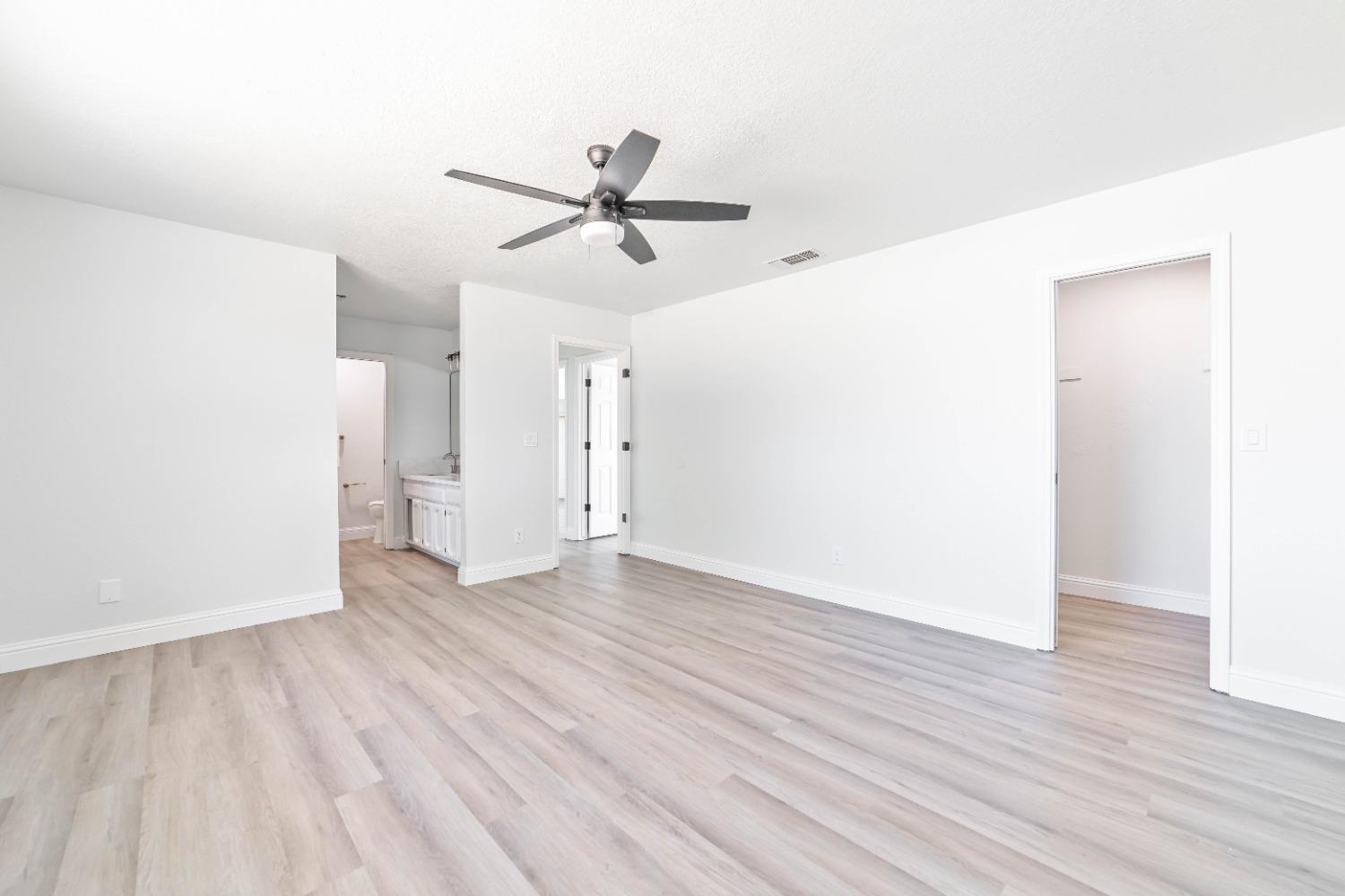 16680 Austin Street Madera, CA 93638 - Photo 17 of 40 a view of empty room with wooden floor and window