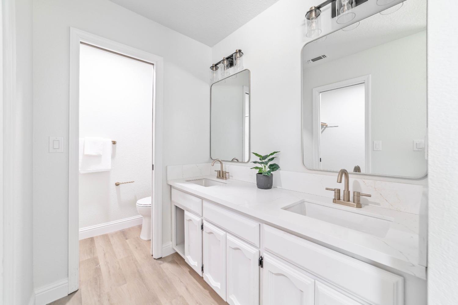 16680 Austin Street Madera, CA 93638 - Photo 18 of 40 a bathroom with a double vanity sink mirror and toilet