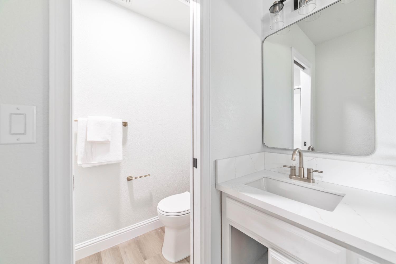 16680 Austin Street Madera, CA 93638 - Photo 19 of 40 a bathroom with a sink a toilet and a mirror