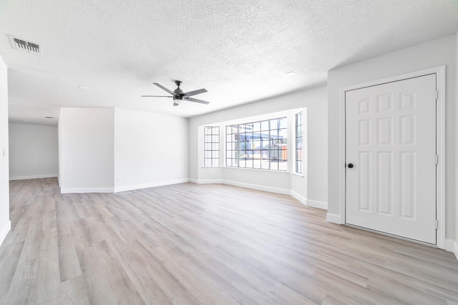 16680 Austin Street Madera, CA 93638 - Photo 2 of 40 wooden floor in an empty room with a window