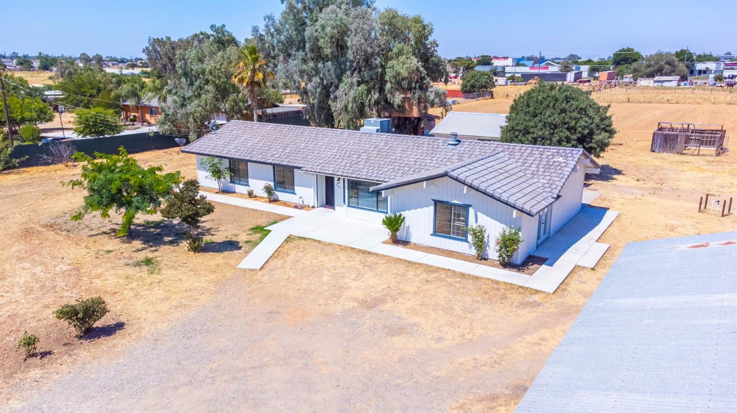16680 Austin Street Madera, CA 93638 - Photo 22 of 40 a house with trees in front of it