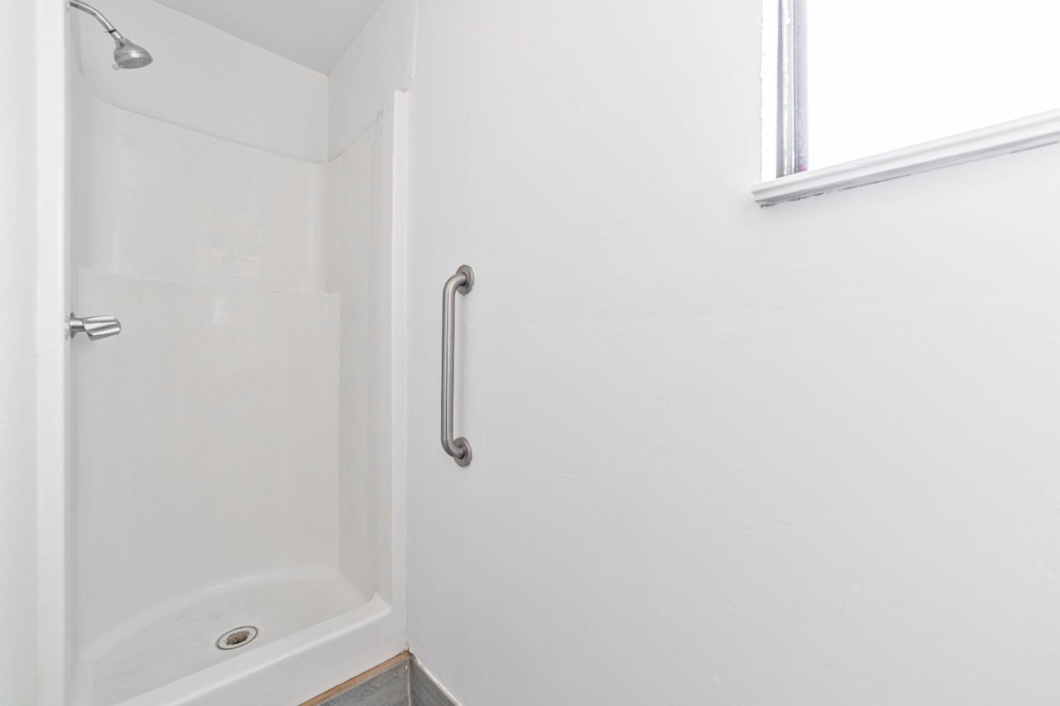 16680 Austin Street Madera, CA 93638 - Photo 38 of 40 a bathroom with a glass shower door