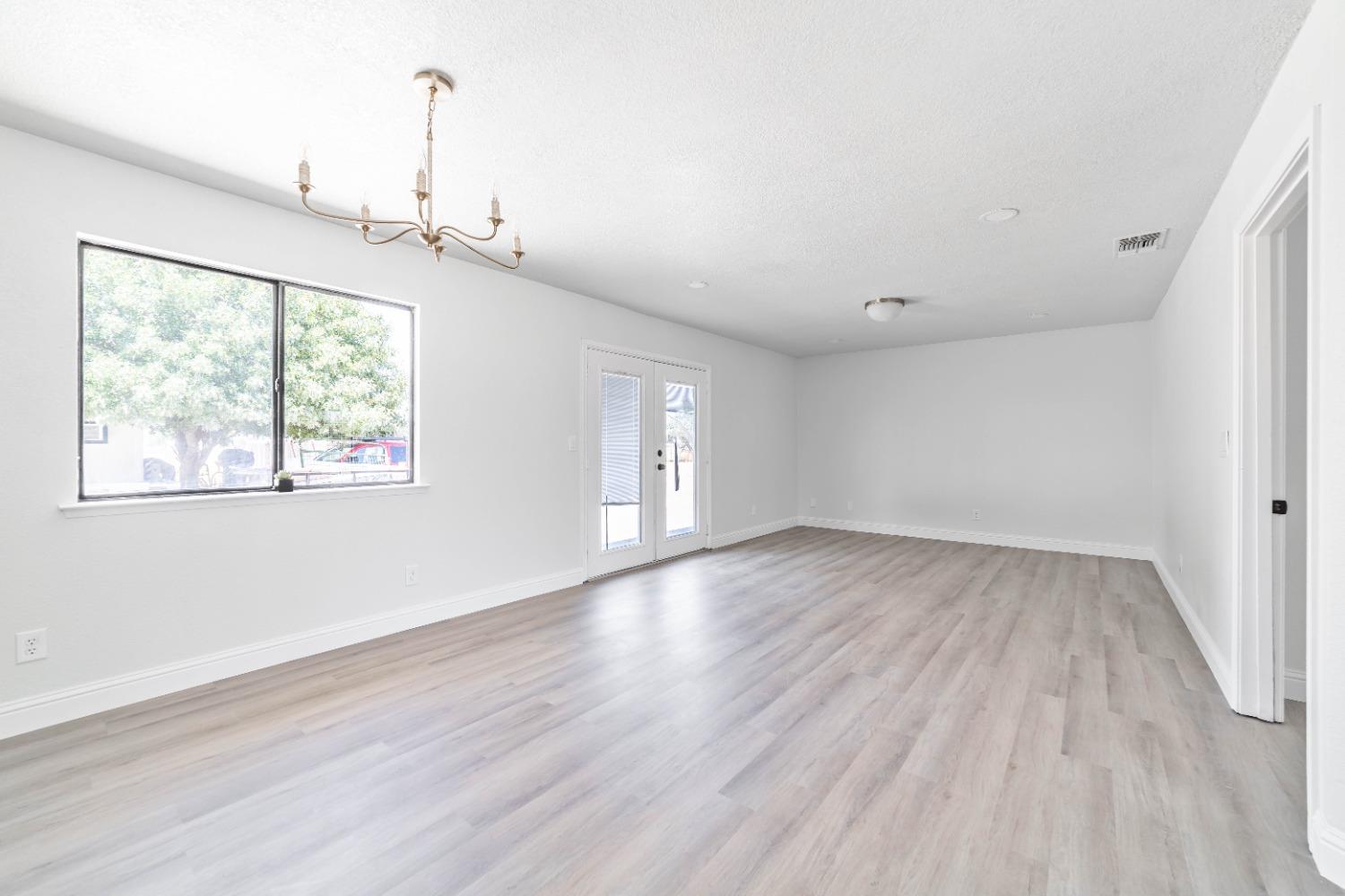 16680 Austin Street Madera, CA 93638 - Photo 6 of 40 wooden floor in an empty room with a window