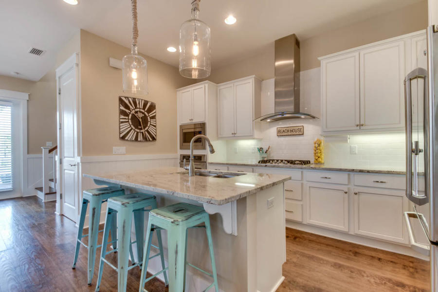 655 Flatwoods Forest Loop Santa Rosa Beach, FL 32459 - Photo 5 of 48 a kitchen with kitchen island granite countertop a sink a counter space appliances and cabinets