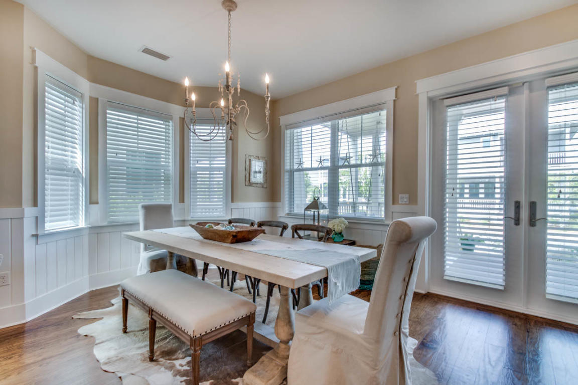 655 Flatwoods Forest Loop Santa Rosa Beach, FL 32459 - Photo 8 of 48 a view of a a dining room with furniture window and wooden floor
