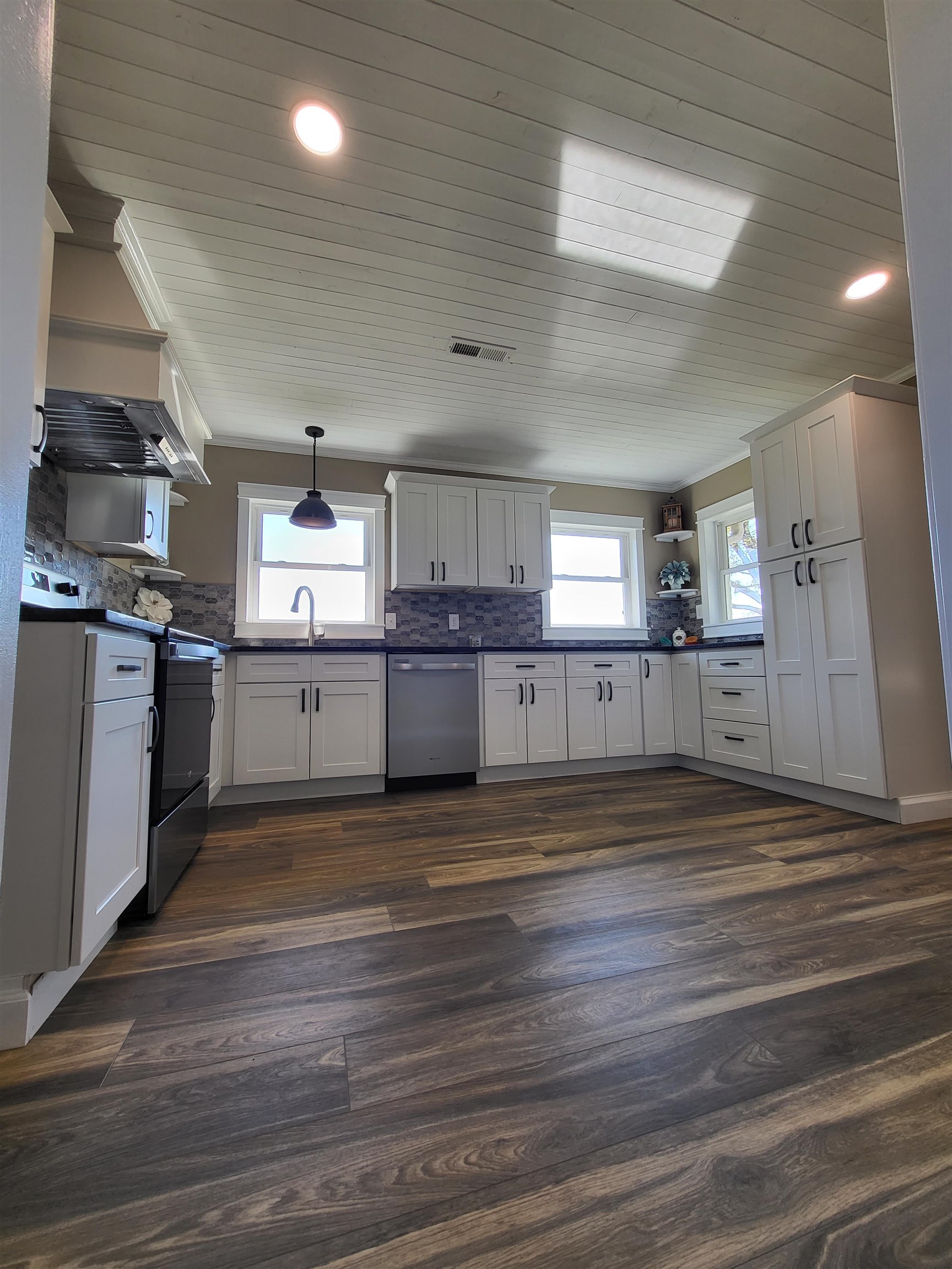 3637 Lightfoot Luckett Road Ripley, TN 38063 - Photo 11 of 25 a view of a kitchen with wooden floor and electronic appliances