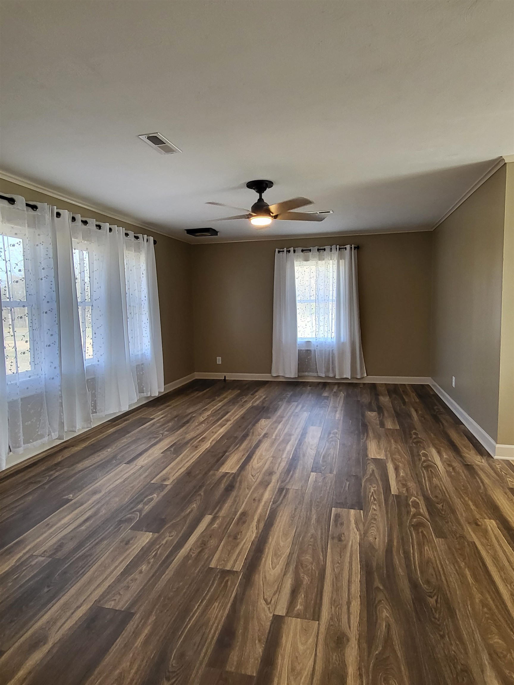3637 Lightfoot Luckett Road Ripley, TN 38063 - Photo 6 of 25 wooden floor in an empty room with a window