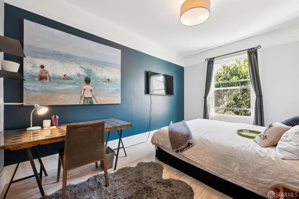 a bedroom with a bed and a desk
