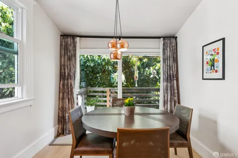 a dining room with furniture a chandelier and window