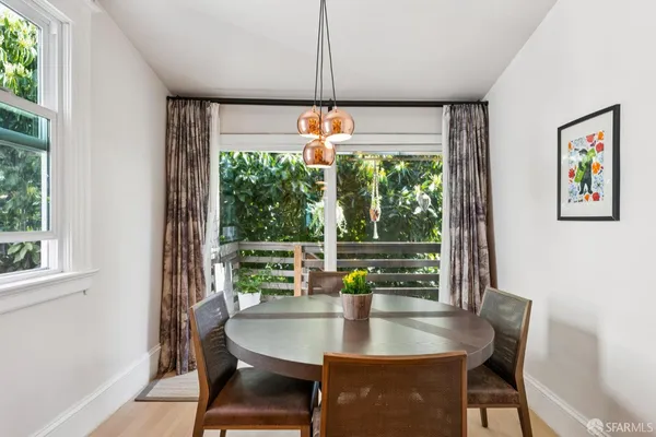 a dining room with furniture a chandelier and window