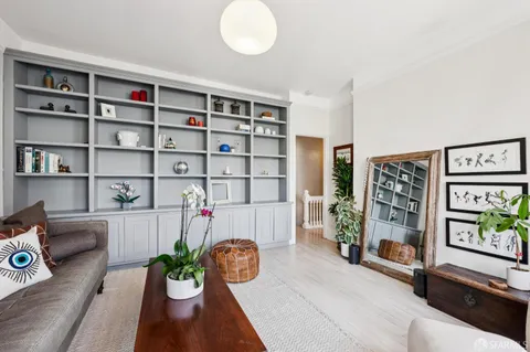 a living room with furniture and a book shelf
