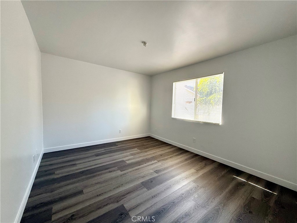 101 Electric Avenue, Unit E Alhambra, CA 91801 - Photo 6 of 10 an empty room with wooden floor and windows