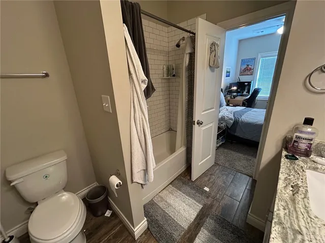 a bathroom with a toilet and a shower
